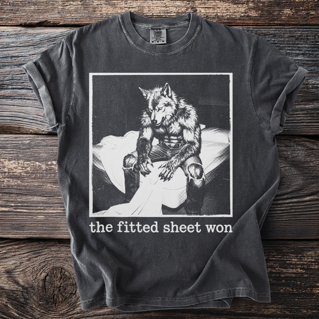 T-shirt with distressed print of a werewolf sitting on a bed, text reads "the fitted sheet won."
