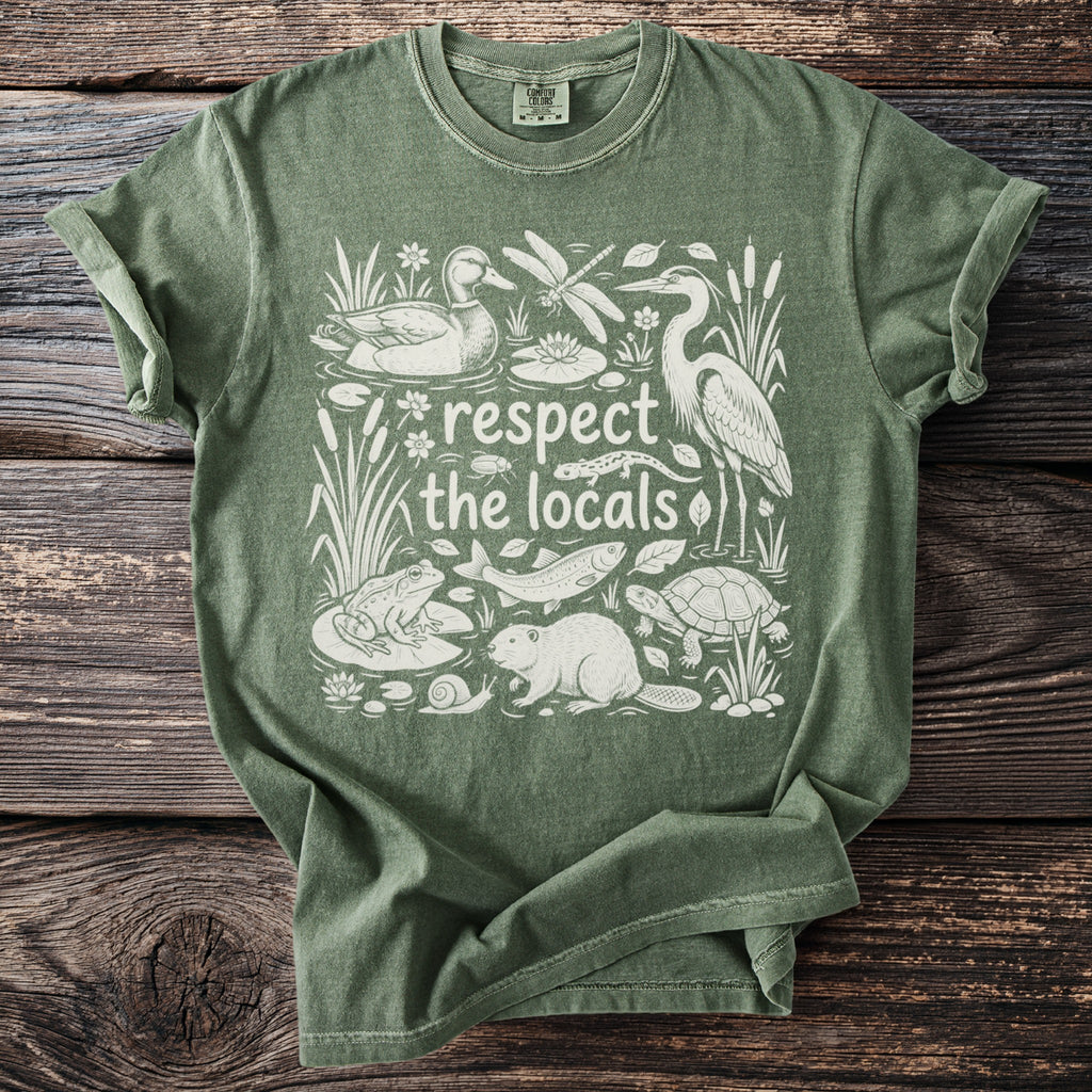 Green t-shirt with white graphic of marsh animals and text "respect the locals".