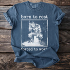 Blue t-shirt with graphic of werewolf sitting on bucket saying "born to rest forced to work".