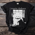 Black t-shirt with text "i require darkness" over a grumpy fluffy cat.
