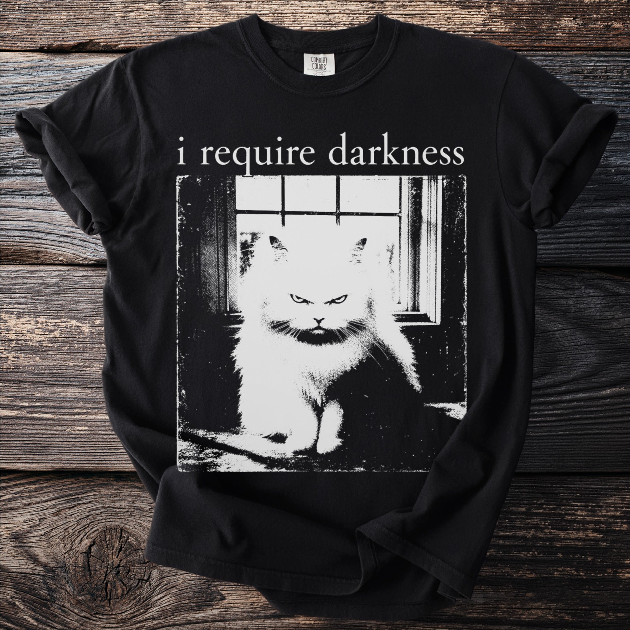 Black t-shirt with text "i require darkness" over a grumpy fluffy cat.