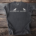 T-shirt with white text and two crows that reads "attempted murder".