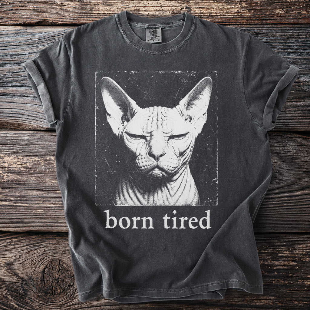 Dark t-shirt with a distressed print of a Sphynx cat and text "born tired".