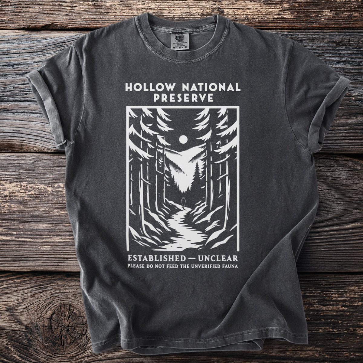 Dark grey t-shirt with "Hollow National Preserve" and forest scene.