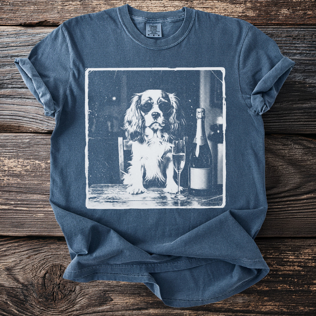 T-shirt with a graphic of a dog wearing sunglasses with champagne.