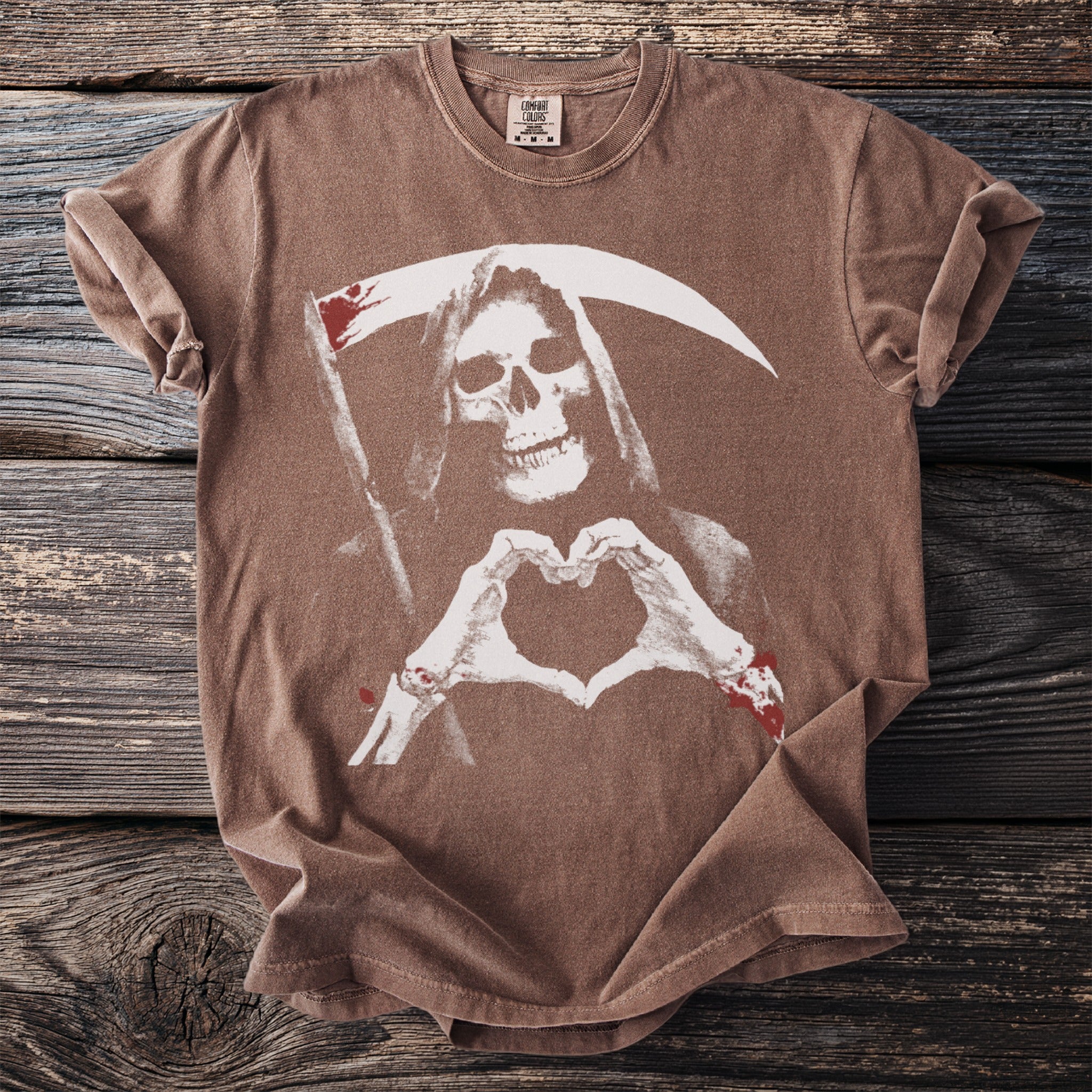 Brown t-shirt with Grim Reaper skeleton making a heart shape with blood splatters.