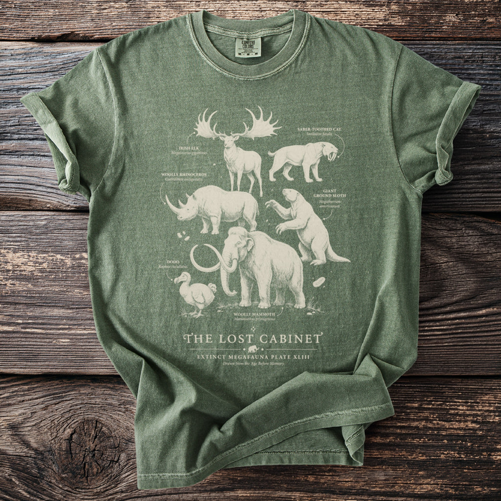 Green t-shirt featuring extinct megafauna illustrations and text "The Lost Cabinet".