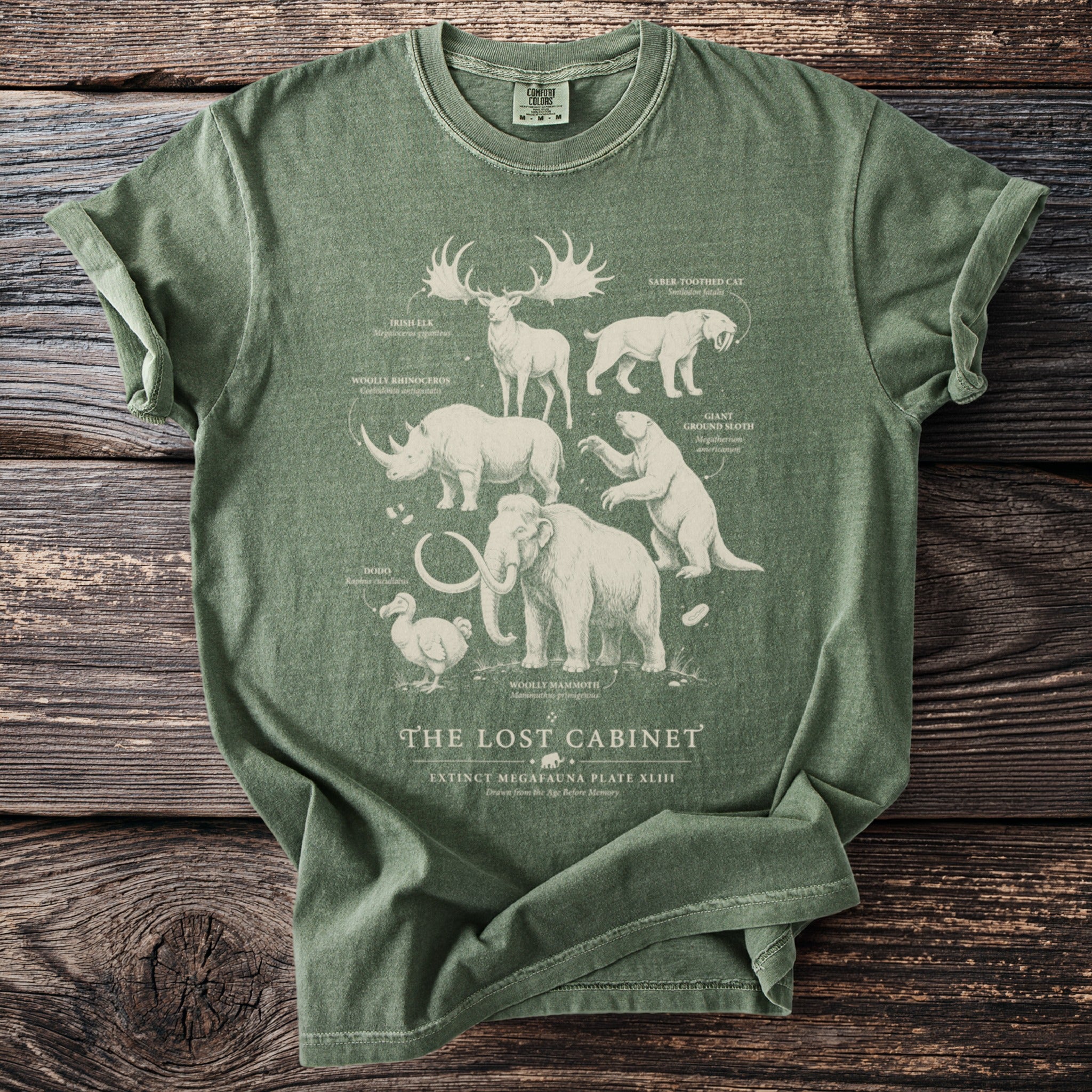 Green t-shirt featuring extinct megafauna illustrations and text "The Lost Cabinet".