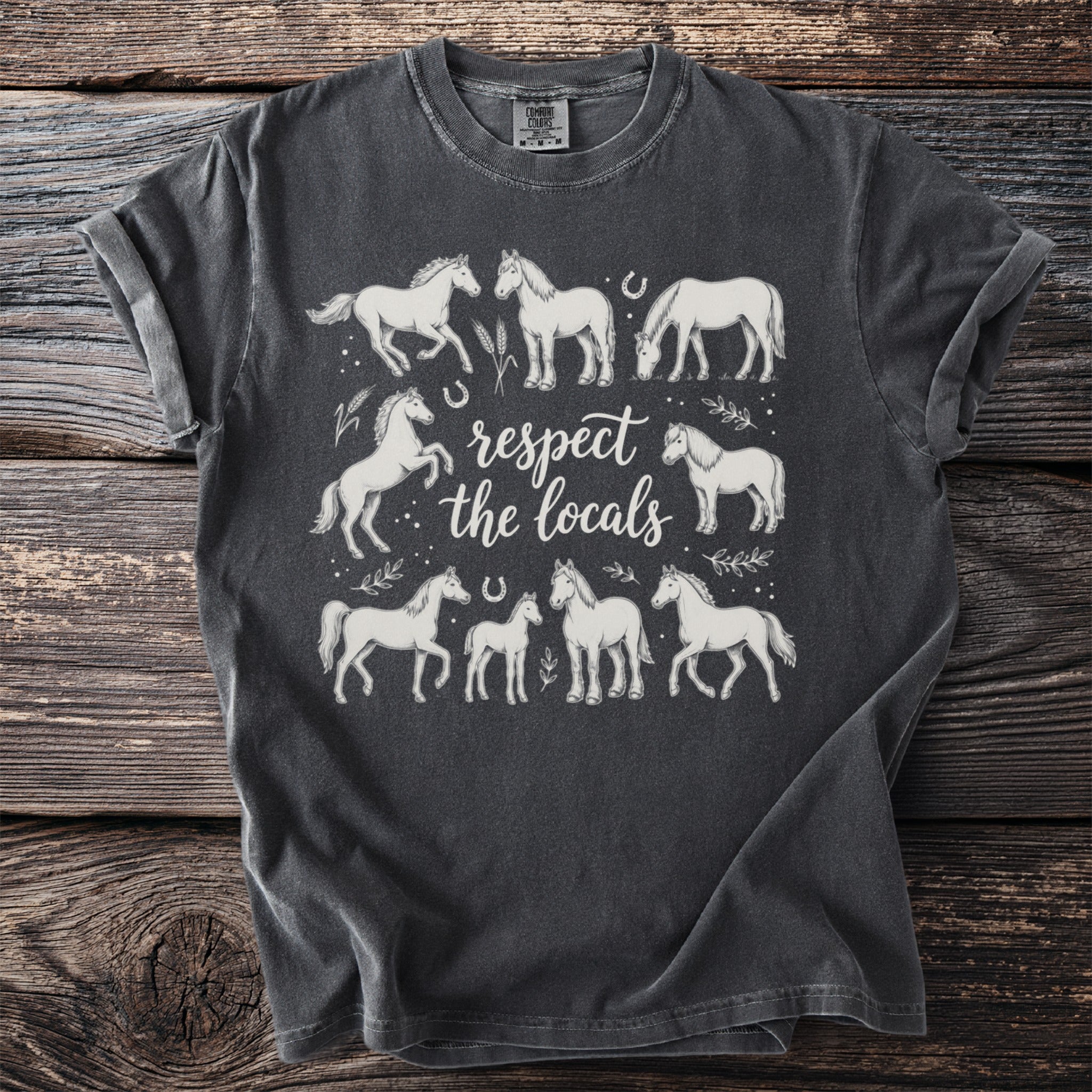 Dark t-shirt with white horse illustrations and "respect the locals" text.