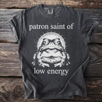 Dark grey t-shirt with white text and graphic of a toad: "patron saint of low energy"