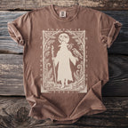 Brown t-shirt with a silhouette of a figure holding a staff and two ravens, surrounded by foliage and runes.