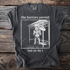 Charcoal t-shirt with graphic of wolf in rain and text "the horrors persist but so do i".