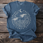 Blue t-shirt with white graphic of a horse and wolf surrounded by runes and a moon.