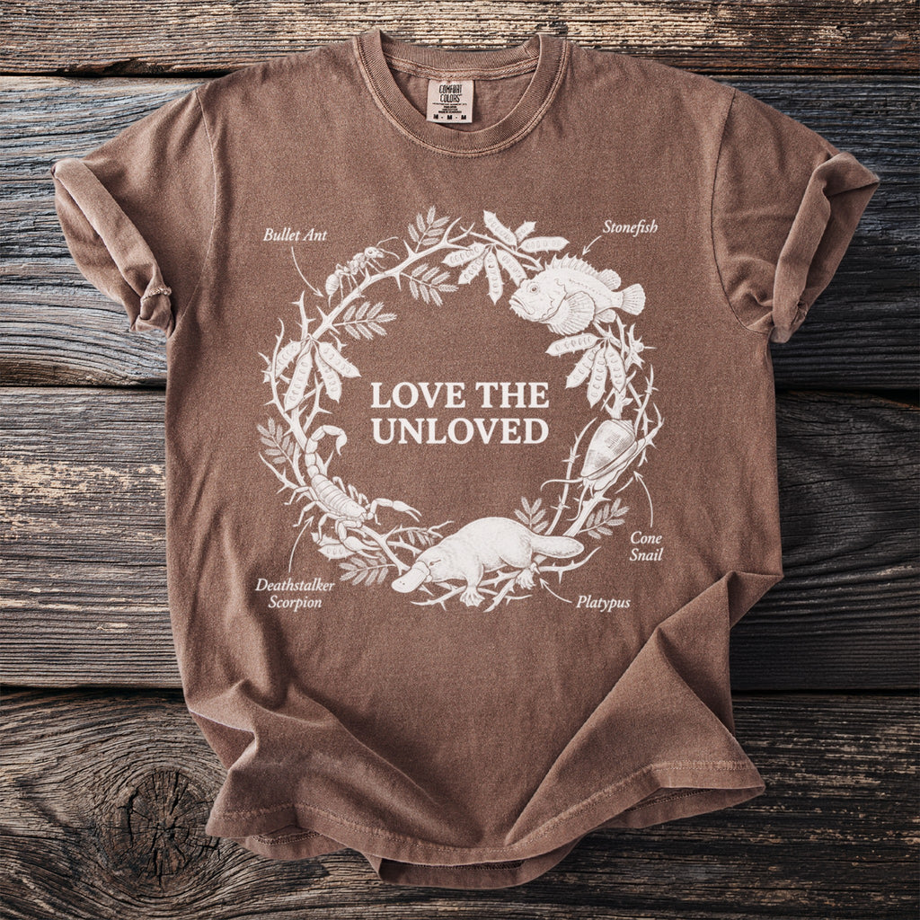 Brown t-shirt with white graphic "LOVE THE UNLOVED" and illustrations of animals.