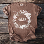 Brown t-shirt with white graphic "LOVE THE UNLOVED" and illustrations of animals.