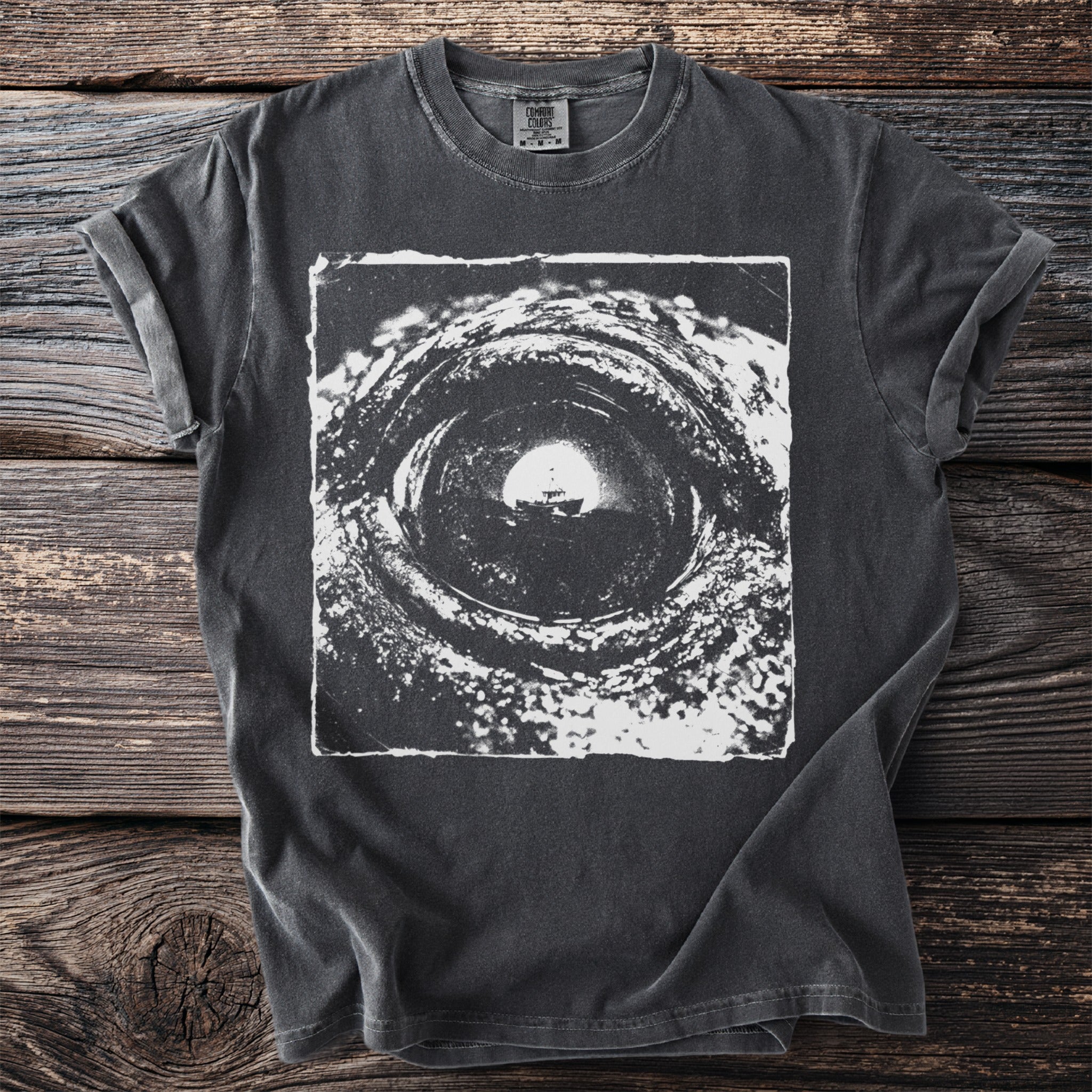 Dark grey Comfort Colors t-shirt with a black and white close-up graphic of a boat in a tunnel.