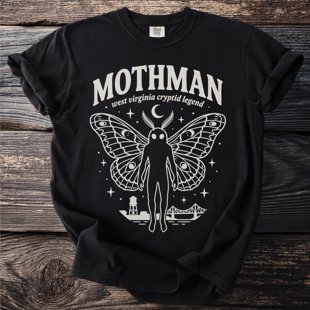 Mothman West Virginia cryptid legend graphic on a black t-shirt with town and bridge detail.