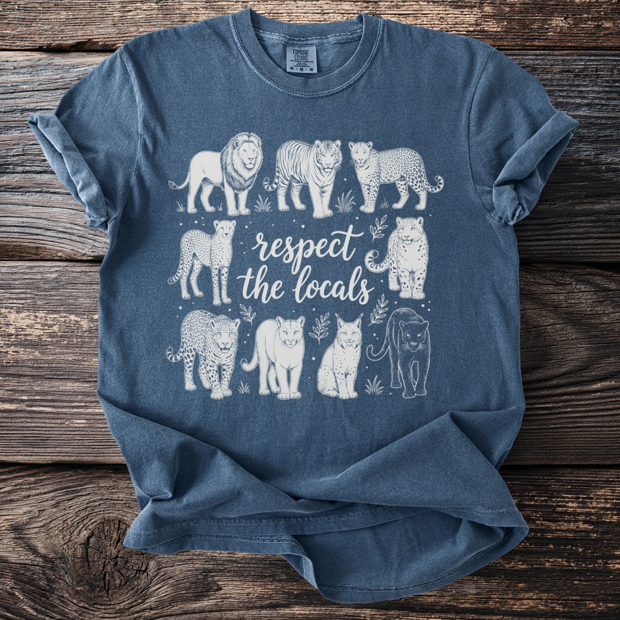 Blue t-shirt featuring line art of various big cats and the text "respect the locals."