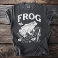 Dark grey t-shirt with white "FROG" text and frog illustration.