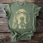 Green t-shirt with a faded graphic of a basset hound wearing glasses.