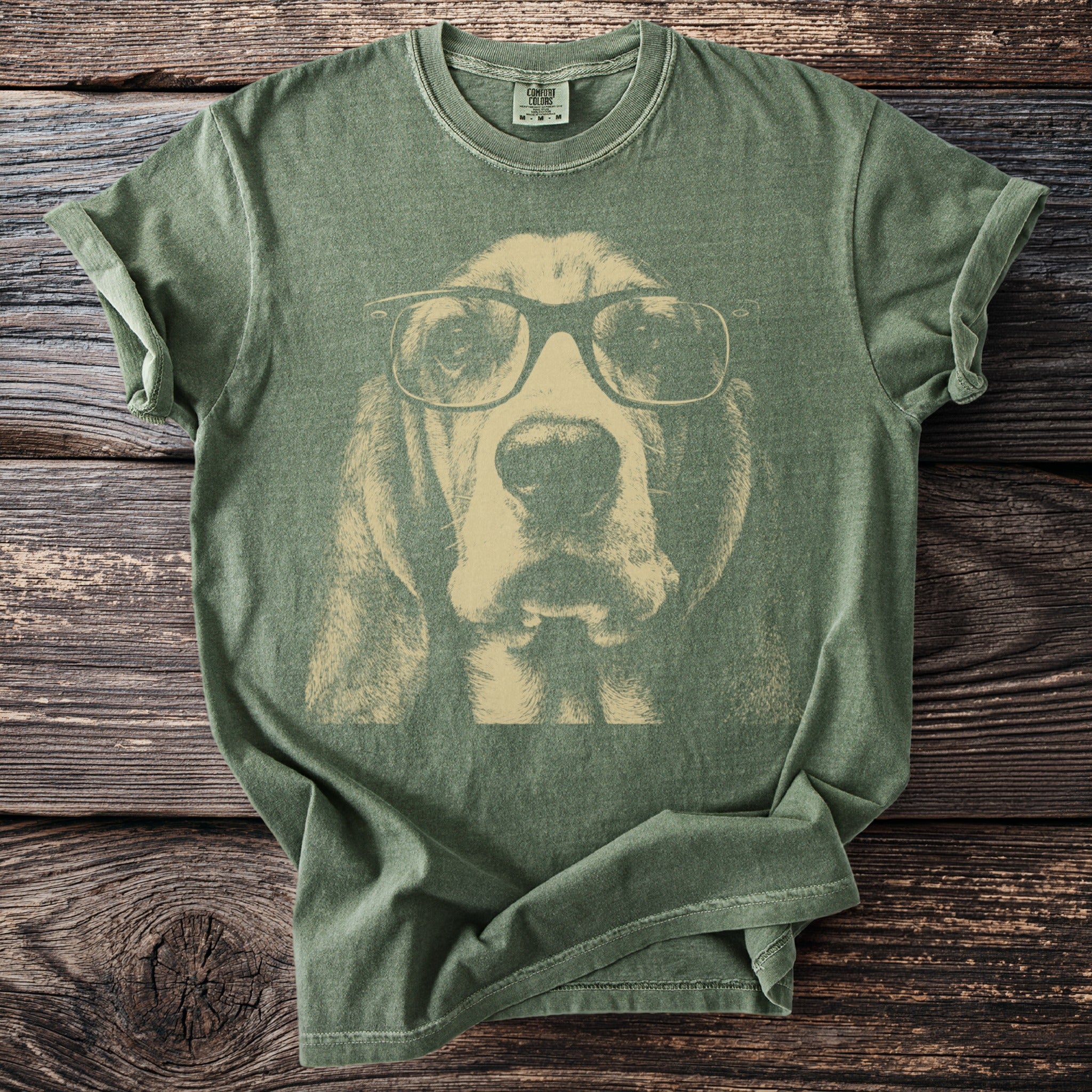 Green t-shirt with a faded graphic of a basset hound wearing glasses.
