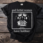 Black t-shirt with "god forbid women have hobbies" and three witches graphic.