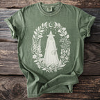 Olive green t-shirt with a white witch and floral moon crescent graphic.