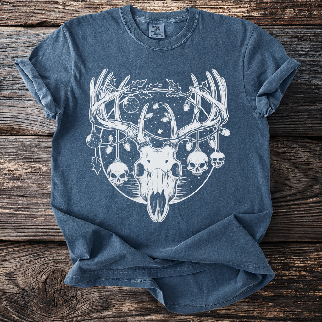 Blue t-shirt with white graphic of deer skull, horns, skulls, and holiday lights.