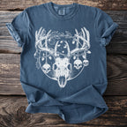 Blue t-shirt with white graphic of deer skull, horns, skulls, and holiday lights.