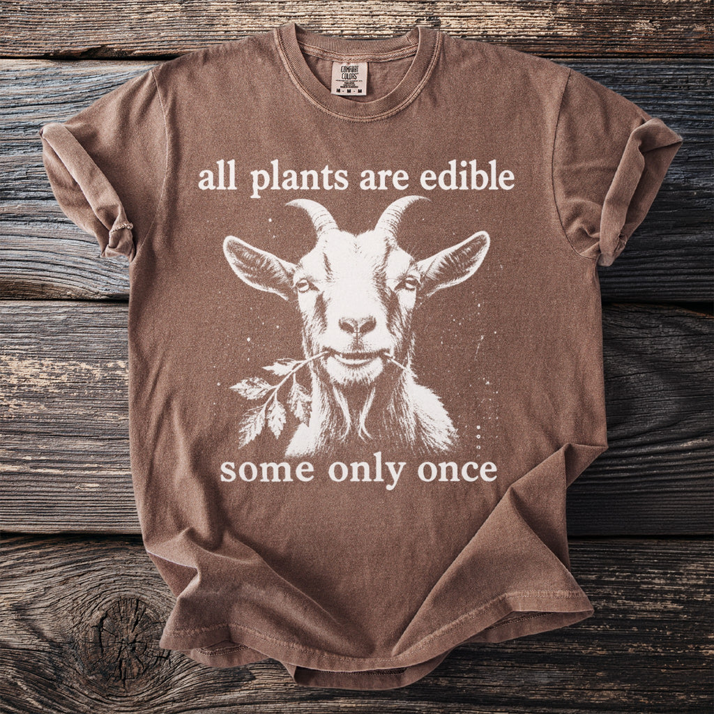 Brown t-shirt with a goat graphic and text: "all plants are edible, some only once."