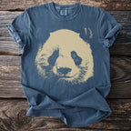 Blue Comfort Colors t-shirt with a faded tan panda face graphic across the chest.