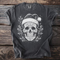 Dark t-shirt with white skull wearing Santa hat and holly graphic.