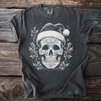 Dark t-shirt with white skull wearing Santa hat and holly graphic.