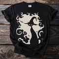 Black t-shirt with a cream-colored graphic of a cat in a witch hat and bats.