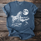 Capybara and cub under a full moon with forest and mountain backdrop.