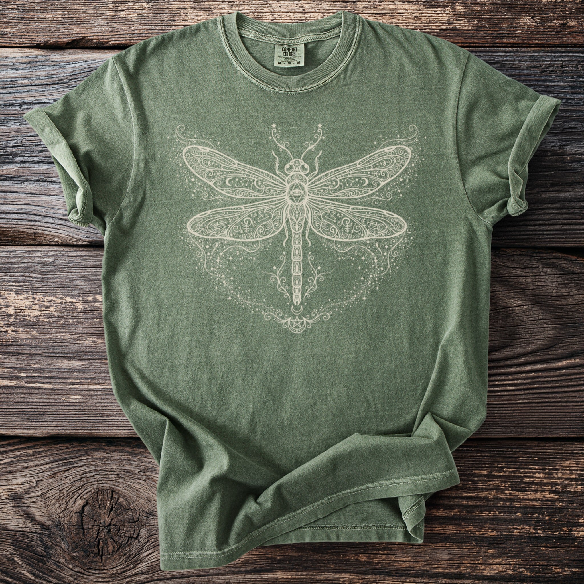 Sage green t-shirt with ornate white dragonfly graphic and 'Comfort Colors' label.