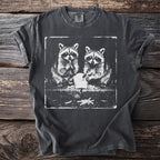 Dark gray t-shirt with a distressed print of two raccoons eating french fries.