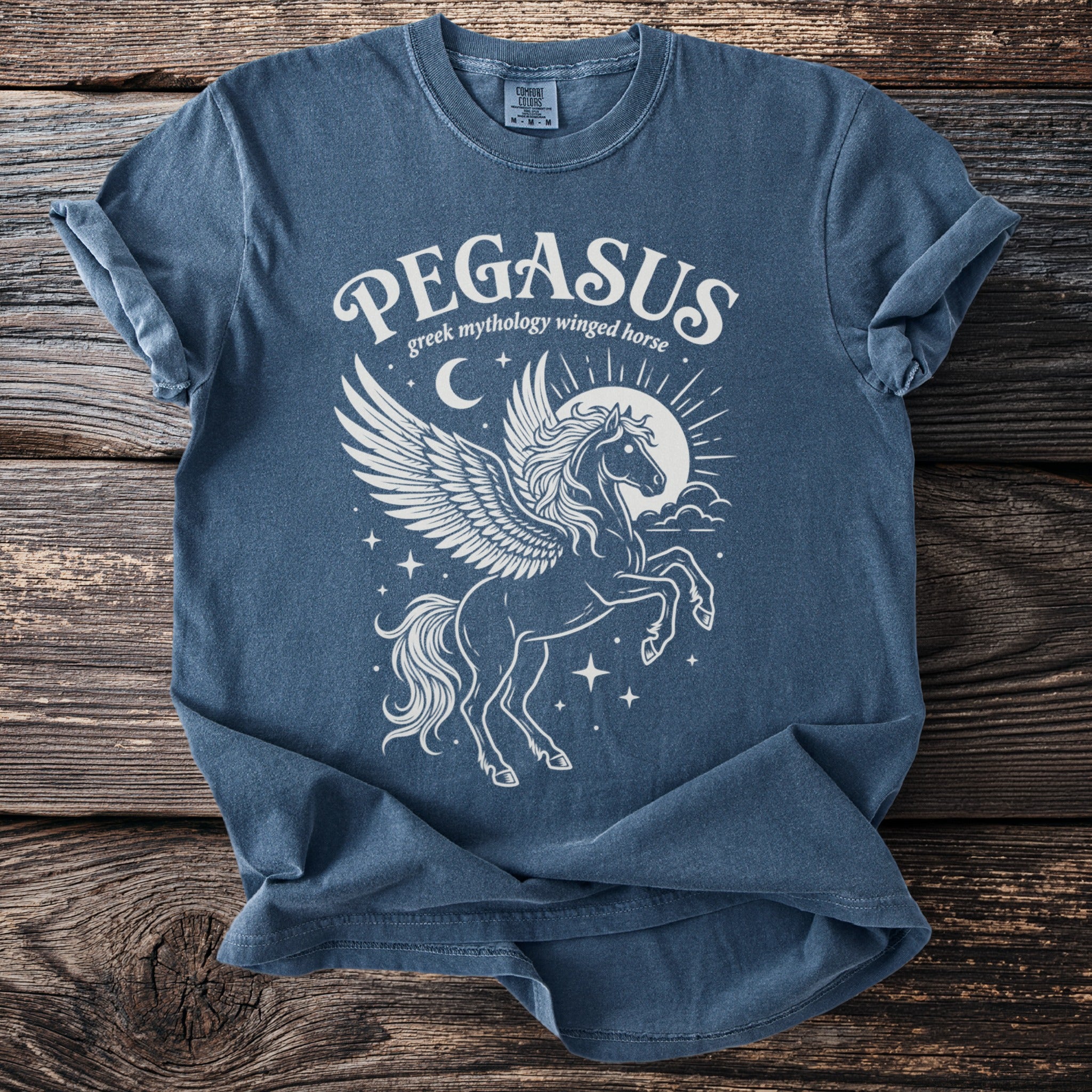 Blue t-shirt with white Pegasus graphic and "Pegasus Greek mythology winged horse" text.