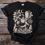 Black t-shirt with image of wizard, owl, moon, mushrooms, and ferns.