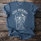 Blue t-shirt with The Hermit tarot card design, including a robed figure, lantern, and mountains.