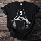 Black t-shirt with white graphic of a person forming a heart with their hands.