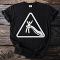 Black t-shirt with white graphic of stick figure in warning sign being pulled by octopus tentacles.