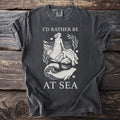 T-shirt with "I'd Rather Be At Sea" text and a graphic of a woman and seals.