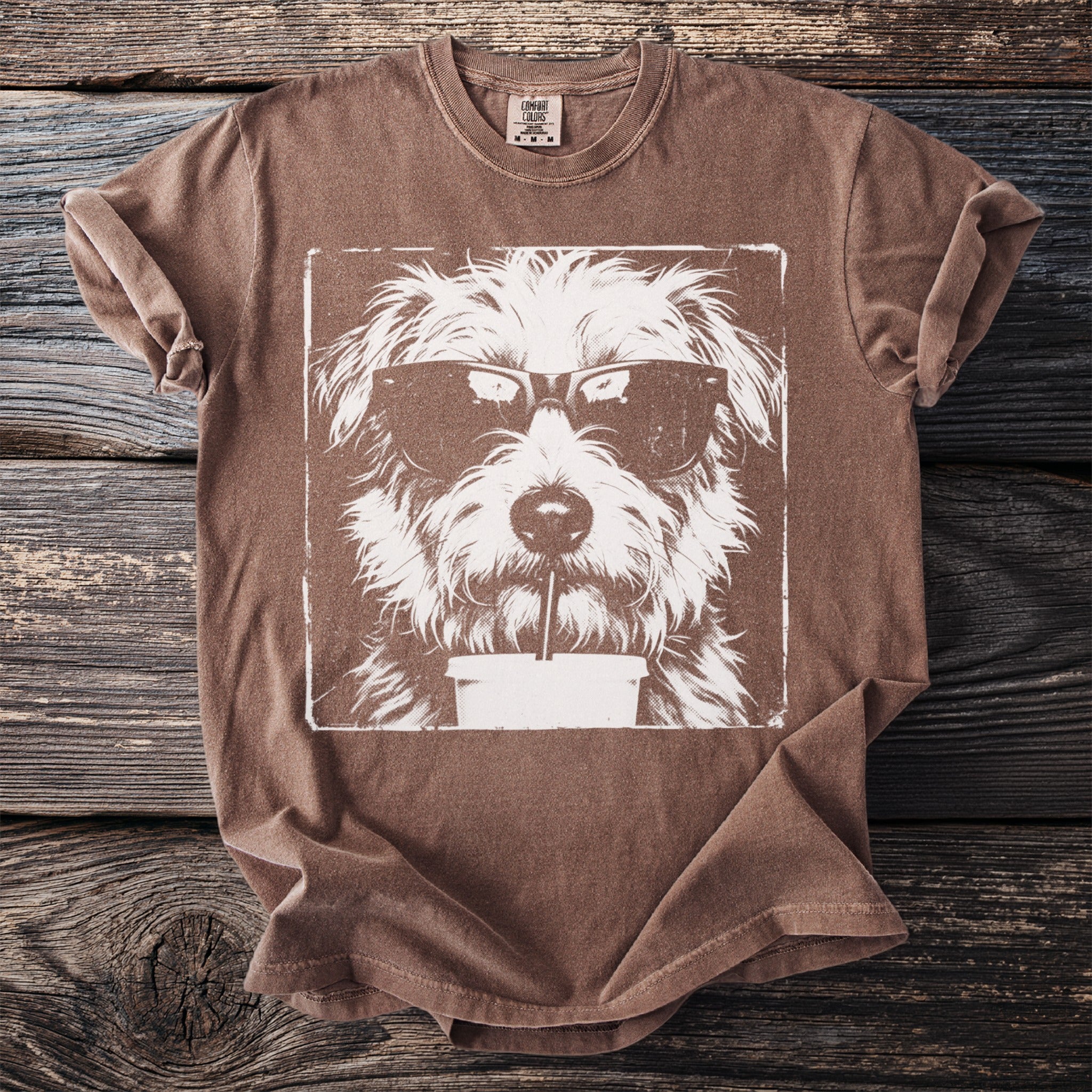 Brown t-shirt with a white graphic of a dog wearing sunglasses and drinking a beverage.