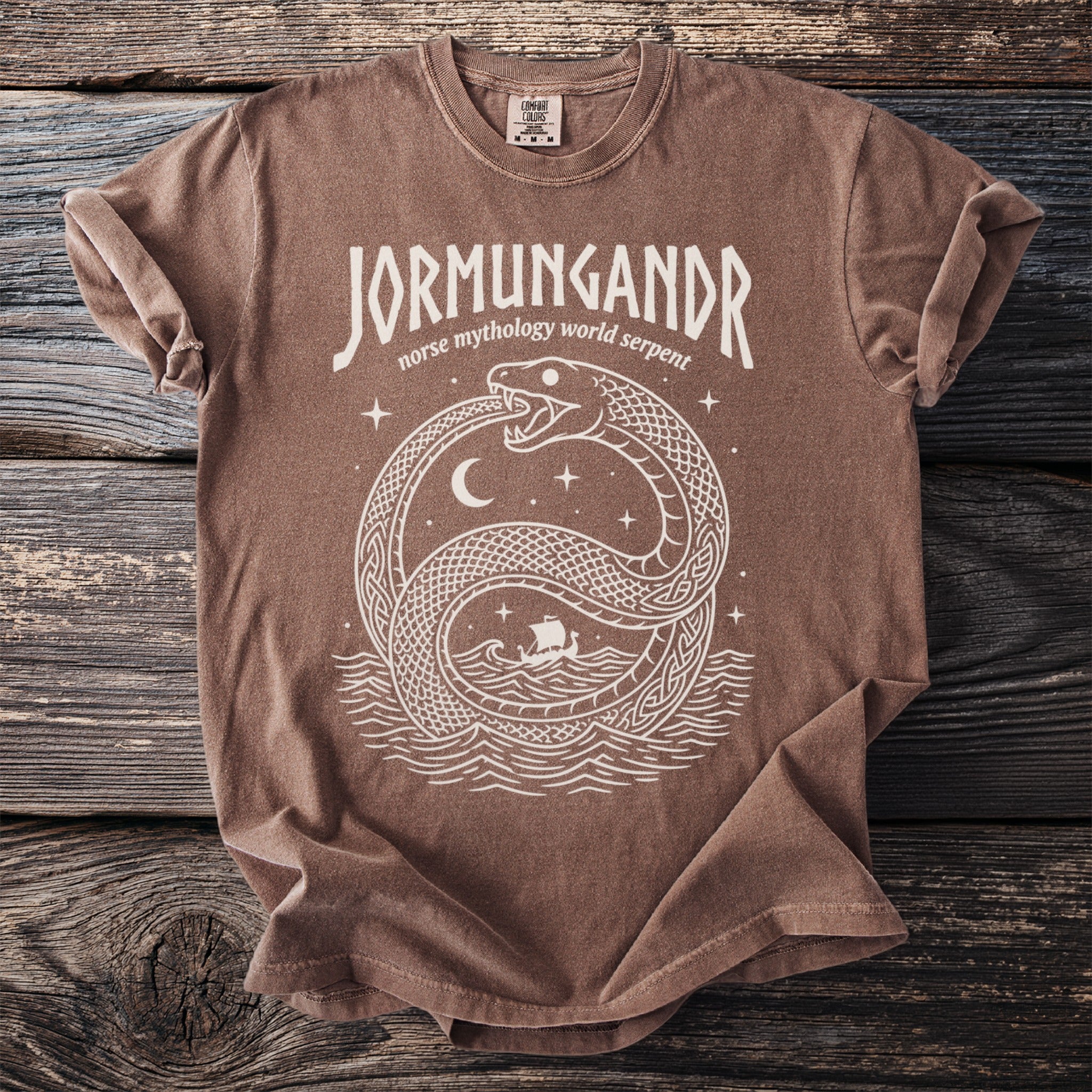 Brown t-shirt with white Jormungandr Norse mythology world serpent graphic.