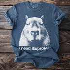 Blue t-shirt with a white graphic of a capybara's face and text "i need ibuprofe".