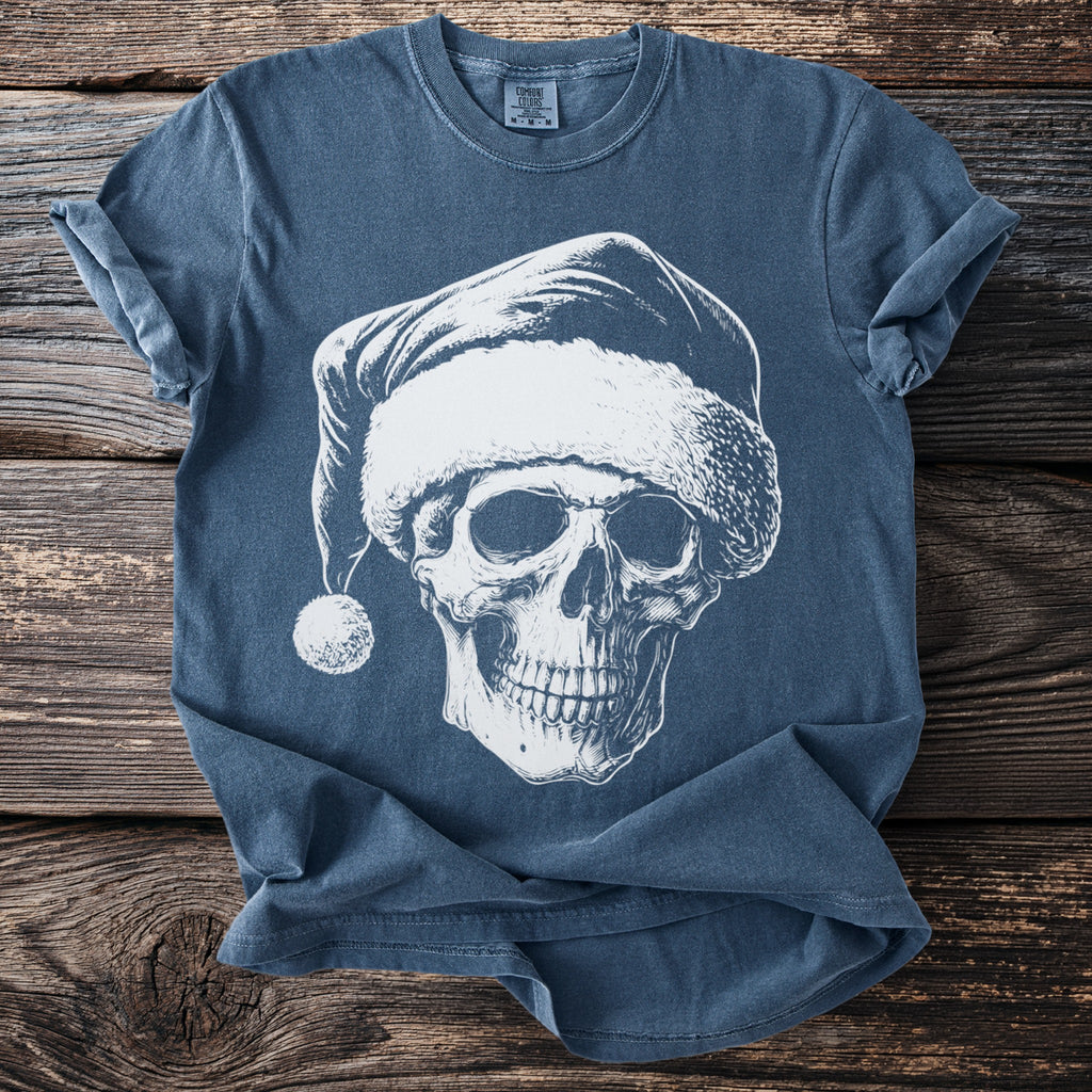 Blue t-shirt with white graphic of a skull wearing a Santa hat and a pom-pom.