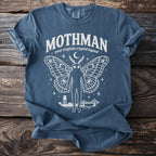 Mothman graphic t-shirt with moth wings, moon, stars, water tower, and bridge.