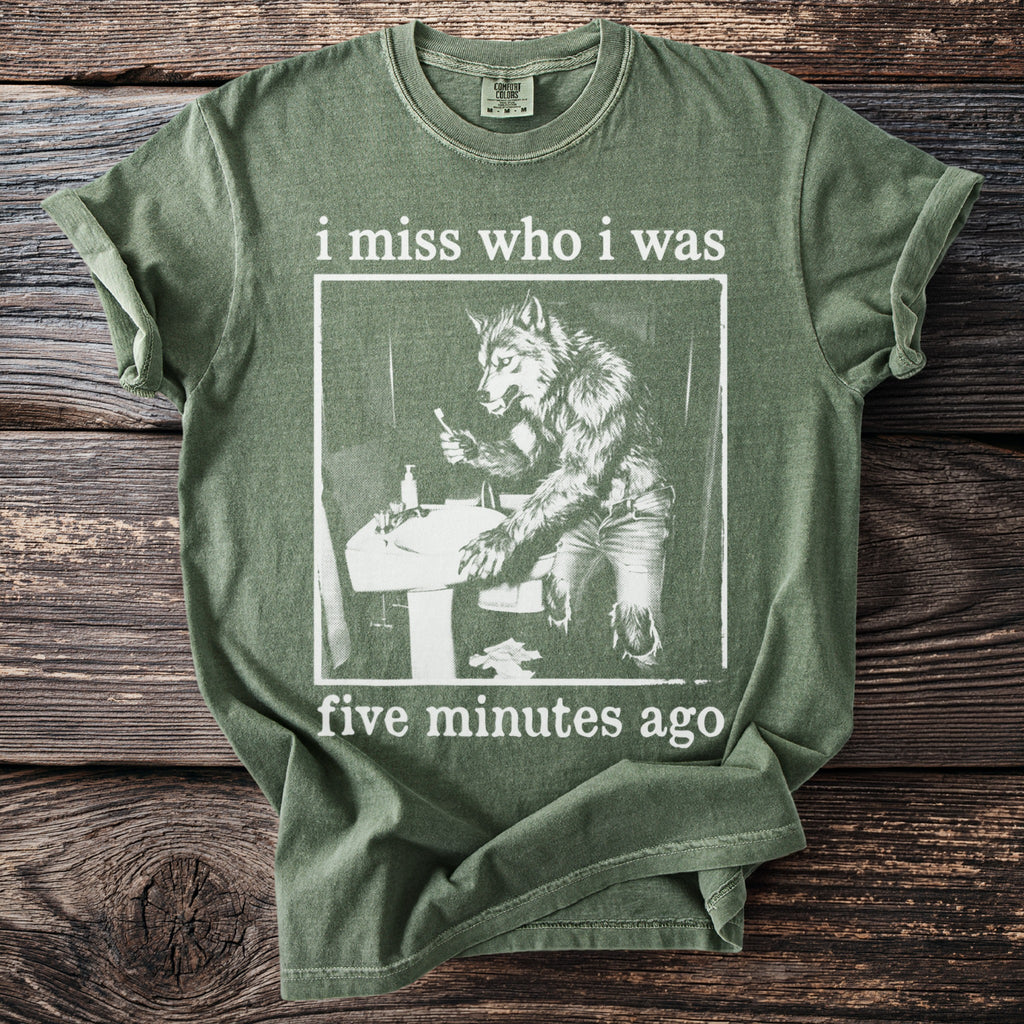 Green t-shirt with werewolf at sink and text "i miss who i was five minutes ago".
