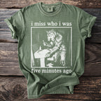 Green t-shirt with werewolf at sink and text "i miss who i was five minutes ago".